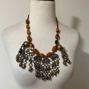 Necklace Amber beads and brass, silk thread.